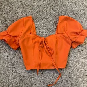 Orange crop to p with ruffles and a bow